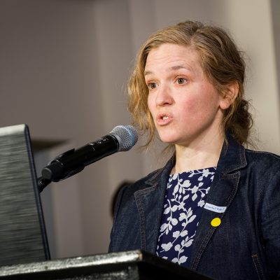 Chantal Trudel, Associate Professor, School of Industrial Design at Carleton University speaks into a microphone at a podium