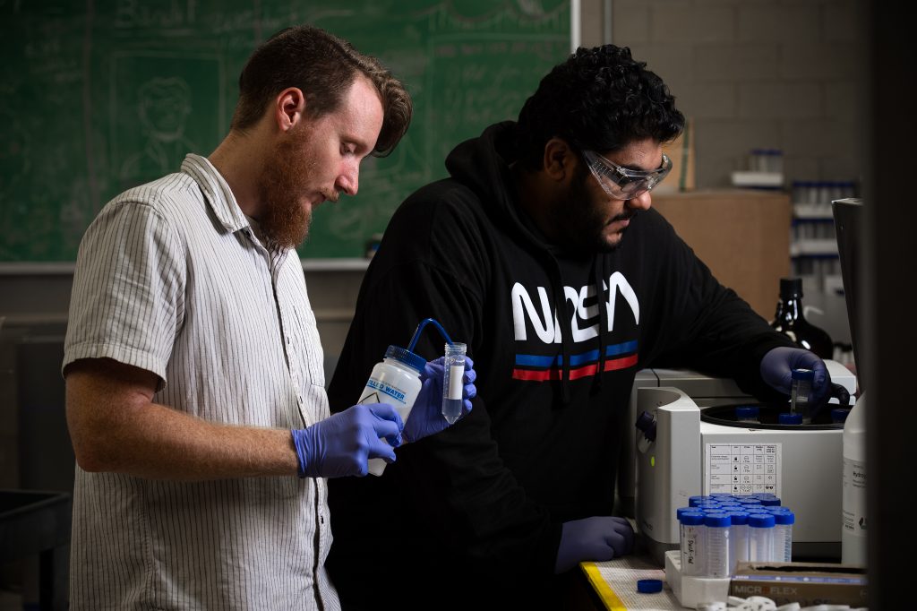 Braden Gregory and Nawaf Nasser employ a centrifuge in their sediment research.