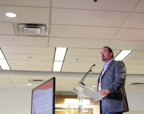 Chief Benedict Abram speaking into a microphone
