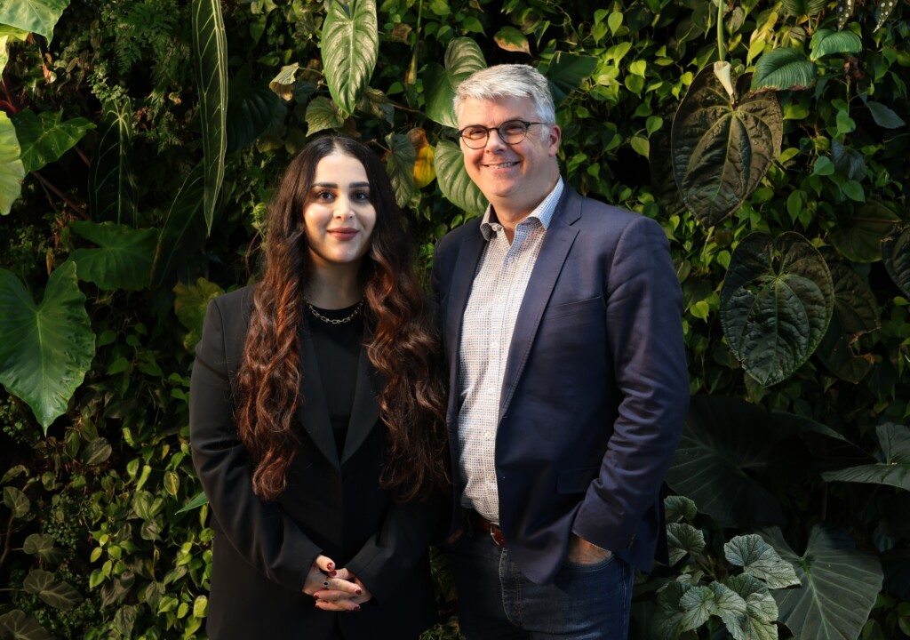 James Milner and Rez Gardi posing in front of a living green wall.