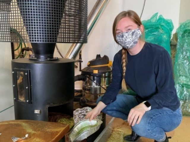 woman crouched by invention